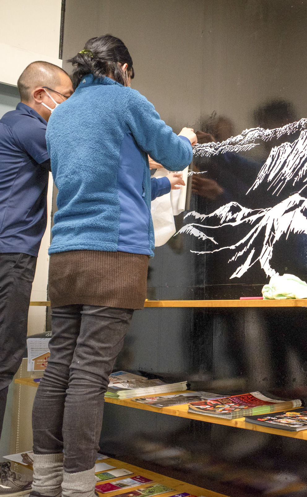 黒い大きな壁に貼られた山のイラストのカッティングシート